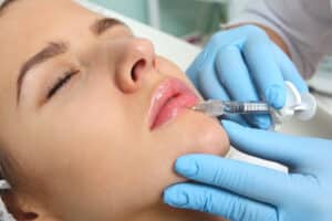 Woman receiving lip fillers.